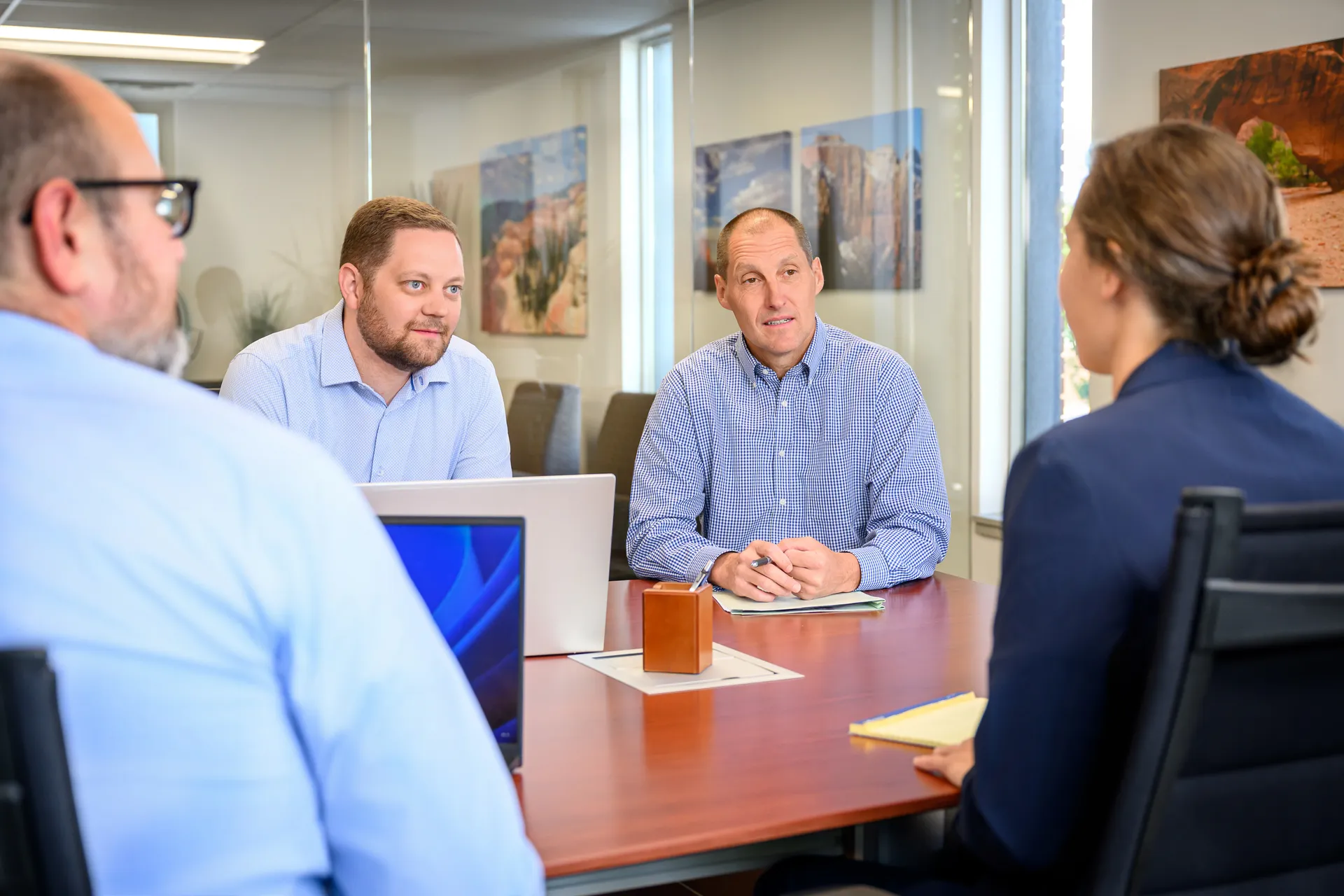 Attorneys meeting with clients around a conference table